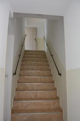 a staircase in a building with wooden floors at Apartmány U Václava - 7 minut od letiště Václava Havla - parkování zdarma in Kněževes