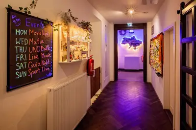 a corridor of a restaurant with a sign on the wall at Prague Dream Hostel in Prague