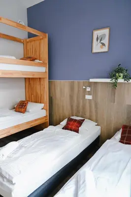 two bunk beds in a room with blue walls at Prague Dream Hostel in Prague