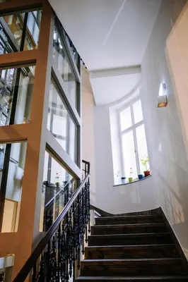 a staircase in a building with two windows at Prague Dream Hostel in Prague