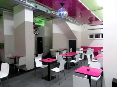 a dining room with pink tables and white chairs at Big Apartment 291 - Rezidence Eliska Prague 9 in Prague