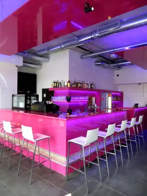 a pink bar with white chairs in a room at Big Apartment 291 - Rezidence Eliska Prague 9 in Prague