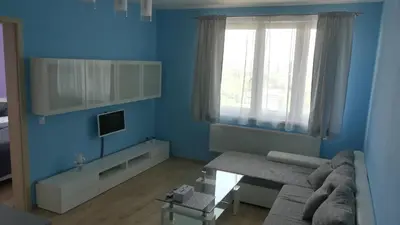 a blue living room with a couch and a table at Big Apartment 291 - Rezidence Eliska Prague 9 in Prague
