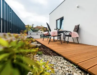 a patio with a table and chairs and a fire pit at Residence Trafick in Prague
