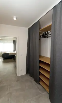 a living room with a bed and a curtain at Residence Trafick in Prague