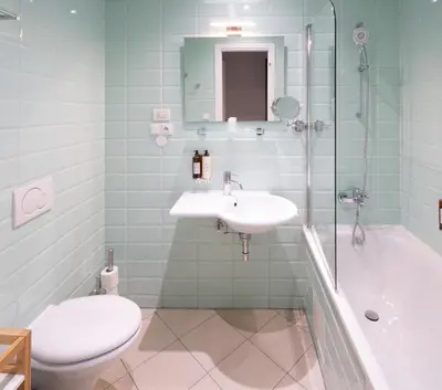 a bathroom with a sink and a toilet and a shower at 4 Elements Apartments in Prague