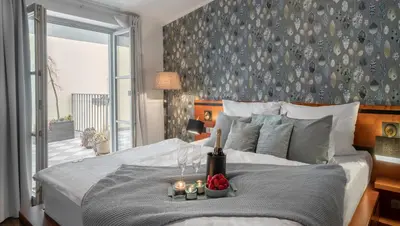 a bedroom with a bed with a table with candles on it at 4 Elements Apartments in Prague