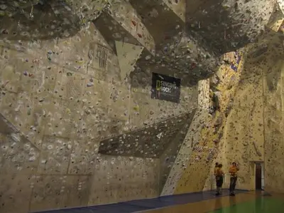 two people standing in front of a climbing wall at Sporthostel Scandinavia in Prague