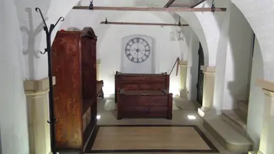 a room with a clock on the wall in a building at 14 Century Water Mill in Mořina