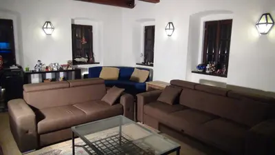a living room with two brown couches and a blue couch at 14 Century Water Mill in Mořina