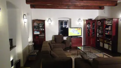 a living room with a couch and a tv at 14 Century Water Mill in Mořina