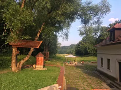 a garden with a tree and a bird house at 14 Century Water Mill in Mořina
