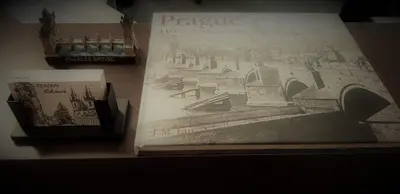 a book on a table with a picture of a city at Hotel Penzion Rohožník in Prague
