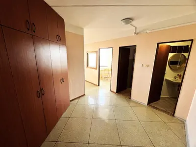 a hallway of a room with wooden cabinets and a bathroom at Hotel Penzion Rohožník in Prague