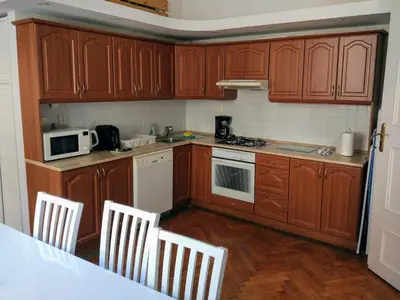 a kitchen with wooden cabinets and white appliances at Apartments Týnská 7 in Prague