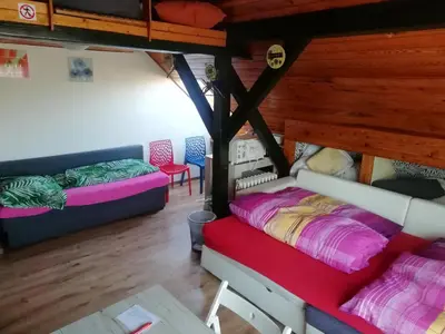 a bedroom with a bed with pillows and a table at Suite Ohrada in Prague