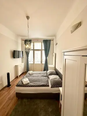 a living room with a table and a couch at Residence Bílkova in Prague