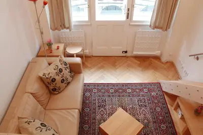 a living room with a red couch and a table at Residence Bílkova in Prague
