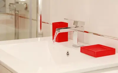 a white bathroom with a tub and a sink at Residence Bílkova in Prague