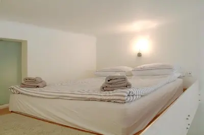 a bedroom with a bed and a dresser and a closet at Residence Bílkova in Prague