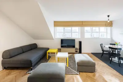 a living room with a couch and a table at Veleslavin Apartments in Prague