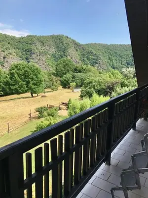 a balcony with a view of a field and mountains at Runch Smilovice in Chotilsko