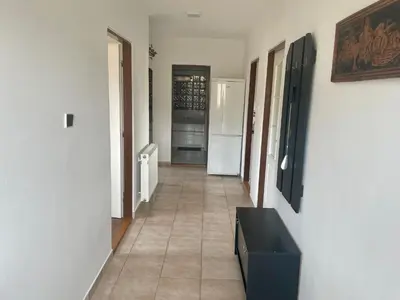 a hallway with a tile floor and a black cabinet at Runch Smilovice in Chotilsko