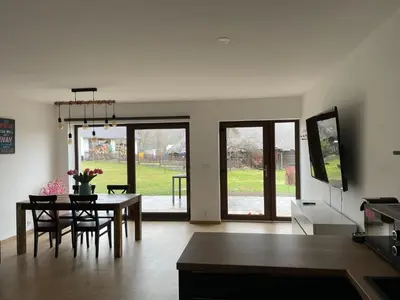 a kitchen and dining room with a table and chairs at Runch Smilovice in Chotilsko