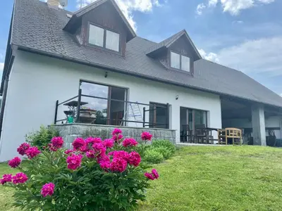 a house with pink flowers in front of it at Runch Smilovice in Chotilsko