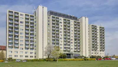 a large white building with a park in front of it at Volha in Prague