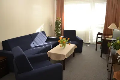 a living room with two blue couches and a table at Volha in Prague