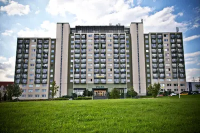a large building with a green field in front of it at Volha in Prague