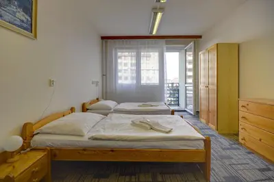 two twin beds in a room with a window at Volha in Prague