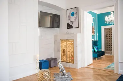 a living room with a fireplace with a tv on the wall at Glamour Frida apartment in Prague