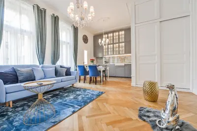 a living room with a blue couch and a blue rug at Glamour Frida apartment in Prague