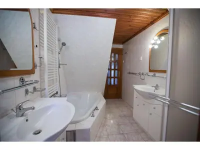 a bathroom with two sinks and a tub and a mirror at CHATA Privlaky in Přívlaky