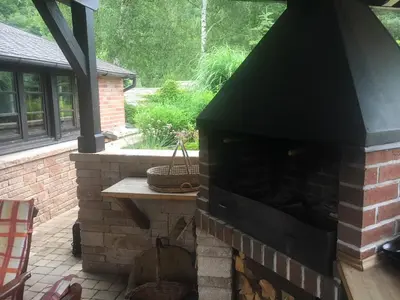 a brick fireplace in a yard with a patio at CHATA Privlaky in Přívlaky