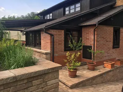 a brick house with potted plants in front of it at CHATA Privlaky in Přívlaky