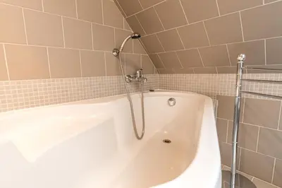 a green tiled bathroom with a sink and a toilet at Penzion Bedrč in Benešov