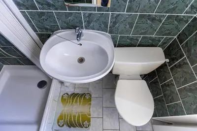 a bathroom with a toilet and a sink and a mirror at Penzion Bedrč in Benešov