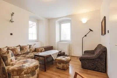 a living room with a couch and a table at Penzion Bedrč in Benešov