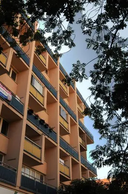 a tall apartment building with balconies and trees at Panorama Prague Castle with Terrace in Prague