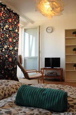 a living room with a couch and a tv at Panorama Prague Castle with Terrace in Prague