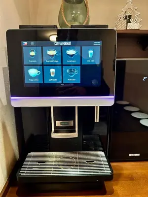 a computer screen on top of a coffee machine at Anyday Apartments in Prague