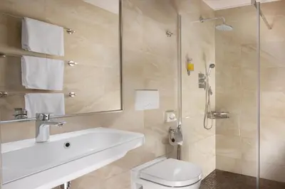a bathroom with a toilet and a sink and a shower at Anyday Apartments in Prague