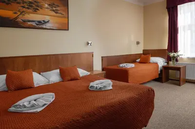 a hotel room with two beds with towels on them at Anyday Apartments in Prague