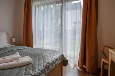 a bedroom with a bed and a large window at Rezidence & Wellness Blatov in Prague