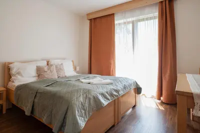 a bedroom with a bed with two white shoes on it at Rezidence & Wellness Blatov in Prague
