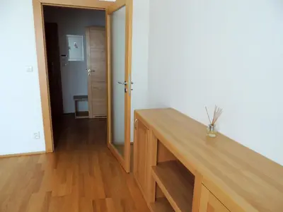 a room with a wooden table and a mirror at Rezidence & Wellness Blatov in Prague