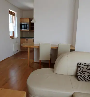 a living room with a white couch and a table at Rezidence & Wellness Blatov in Prague